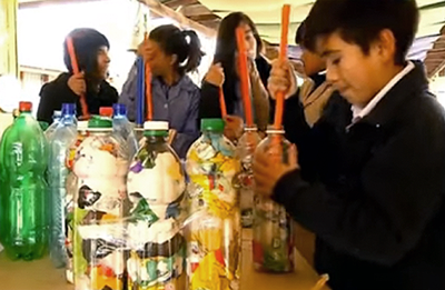 Estudiantes elaborando ecoladrillos con botellas plásticas.